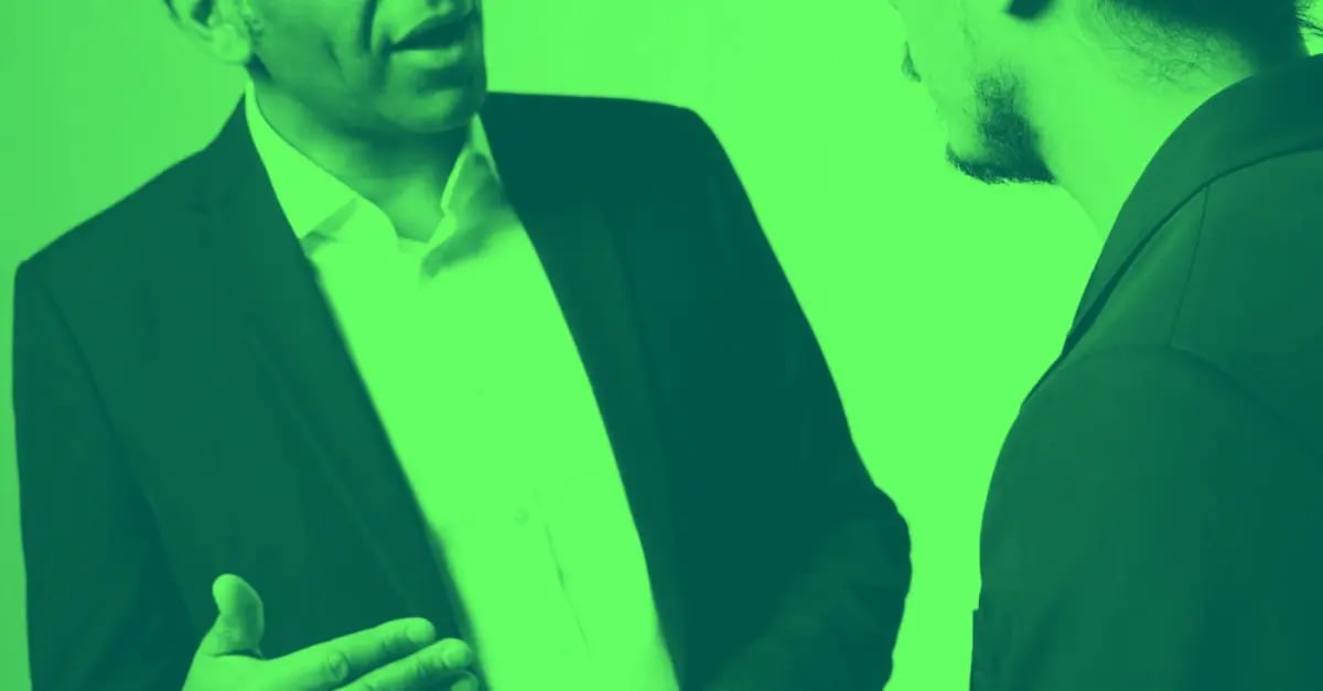 A man using leadership skills to speak to an employee