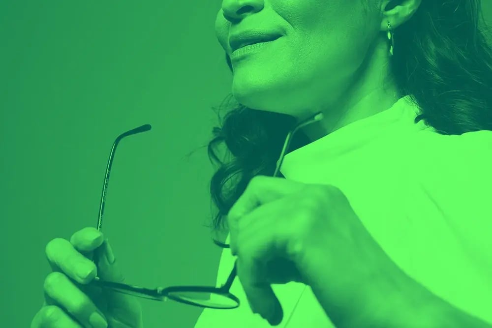 A woman holding glasses