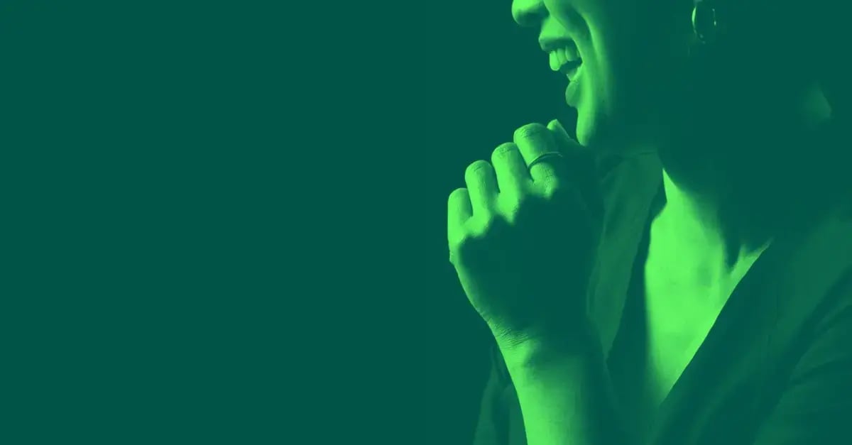 woman-smiling-with-one-hand-green-mask-1200x627