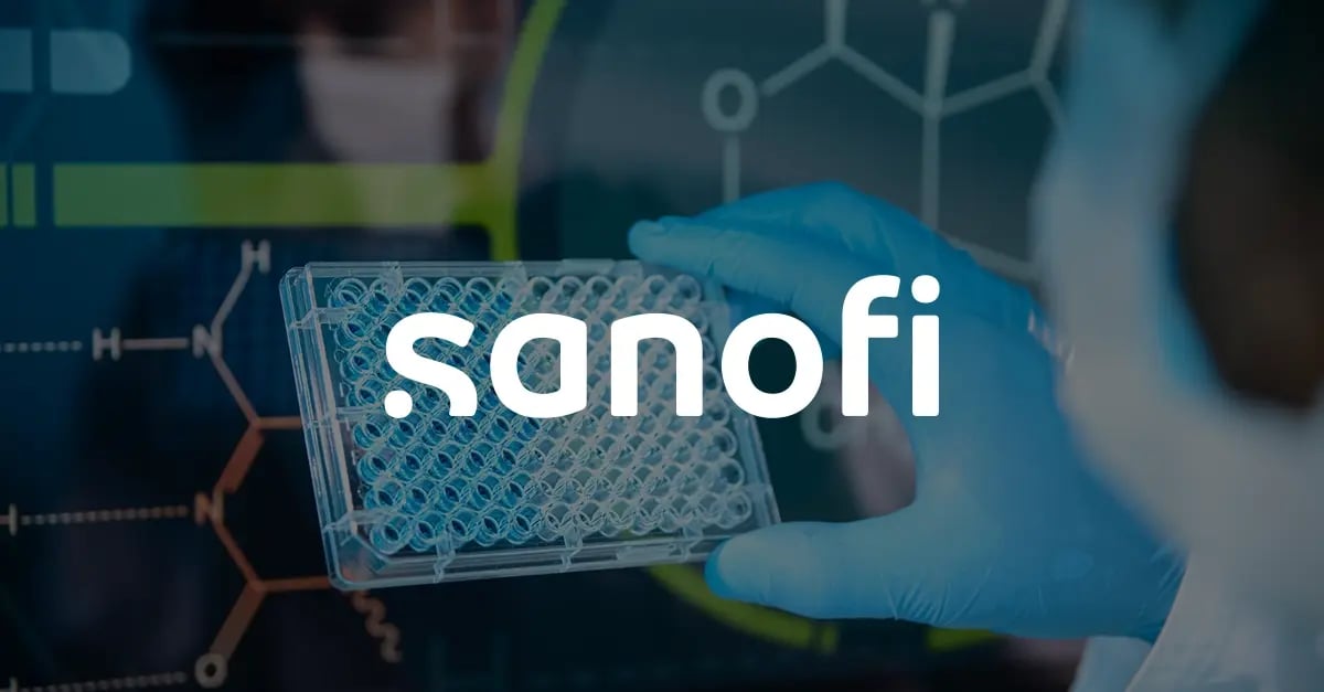 Photo of a man in a lab coat and PPE a test tube holder with a white version of the Sanofi logo superimposed in the middle foreground