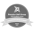 Brandon hall 2023 gold awards badge for leadership development in greyscale