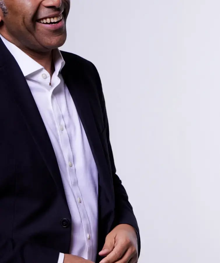 Photo of a man in a dark sport coat smiling