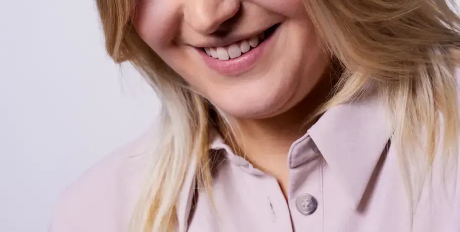 Close-up photo of a blonde haired woman's face and smile